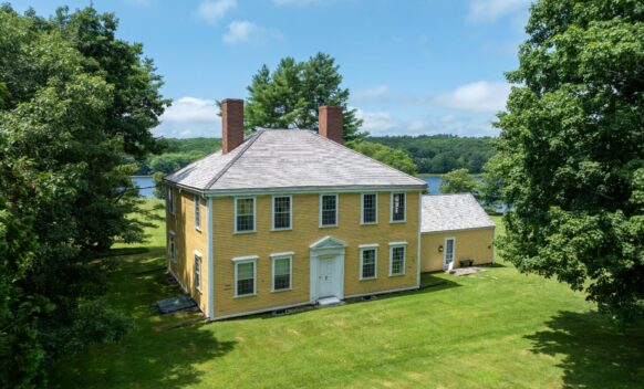 An aerial view of the front of Bowman House. Water is visible in the background.