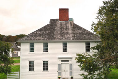 A photo of the exterior of Casey Farm showing green grass and trees.