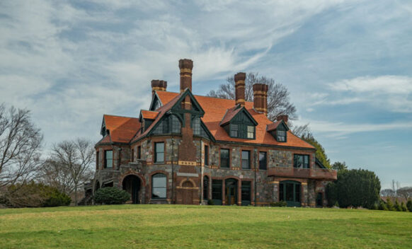 An exterior photo of Eustis Estate as seen across a lush green lawn.