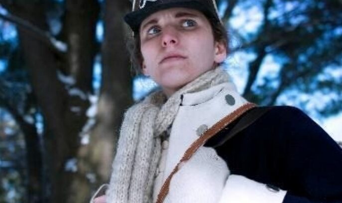 A photo of a woman in a Revolutionary War soldier's uniform.